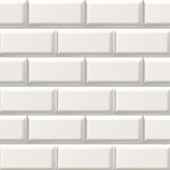 Gros plan de l'impression : biseau d'un carreau blanc cassé, arête claire en haut et ombre grise en bas, sur un papier resté lisse.