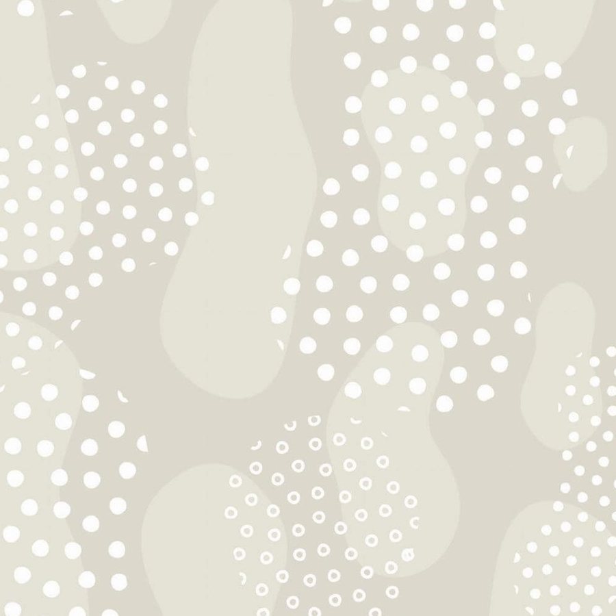 Gros plan de l'impression : bord net des pois blancs posés sur un aplat beige légèrement nuancé.