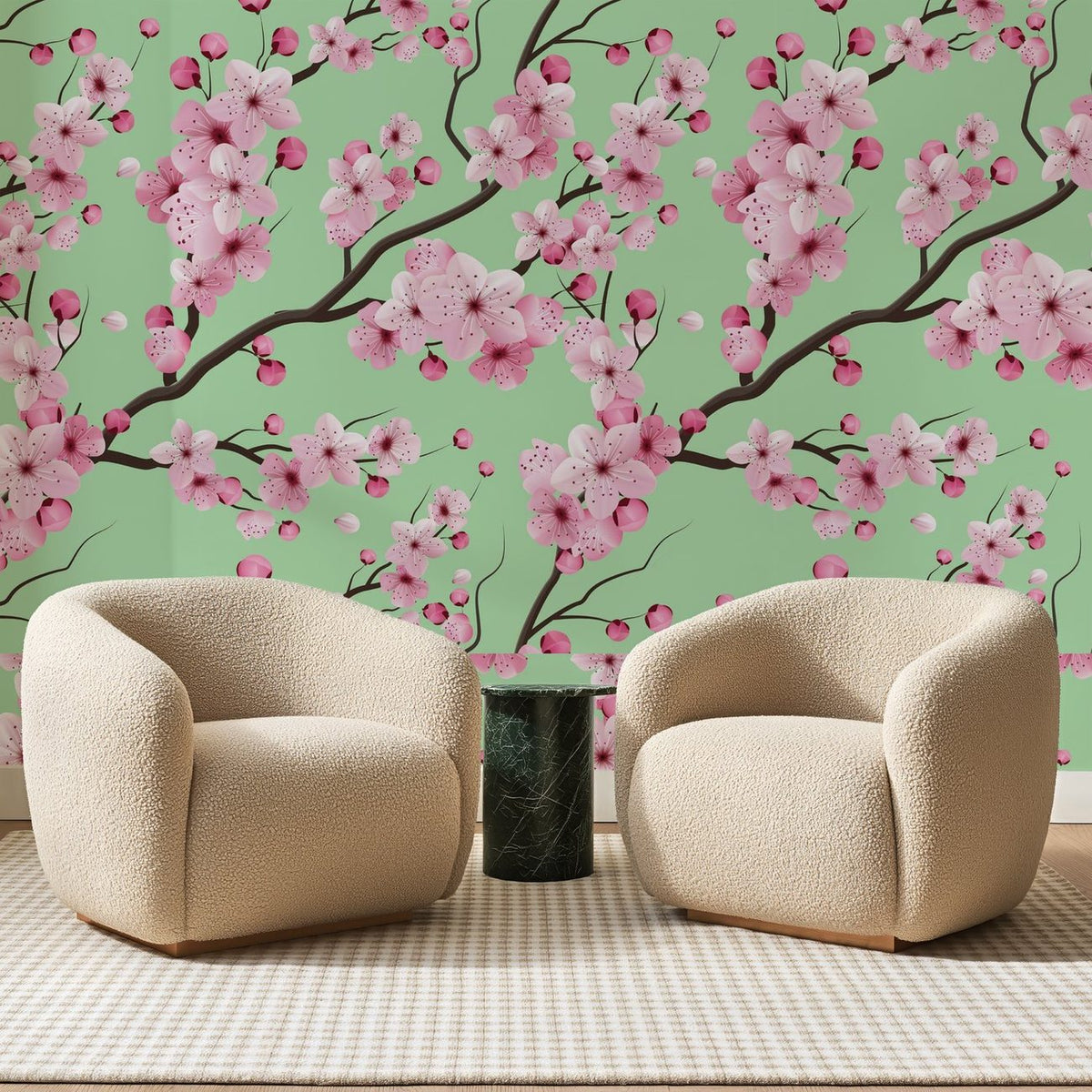 Papier peint panoramique Cerisier En Fleurs Vert Amande, posé sur toute la paroi d'un salon, derrière deux fauteuils en bouclette crème et un guéridon en marbre vert