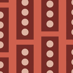 Gros plan de l'impression : deux pois rose poudré et l'angle d'un rectangle brique sur le fond corail.