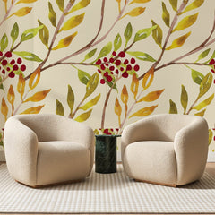 Papier peint panoramique Branches de Sorbier Ambrées, posé sur toute la paroi d'un salon, derrière deux fauteuils en bouclette crème et un guéridon en marbre vert